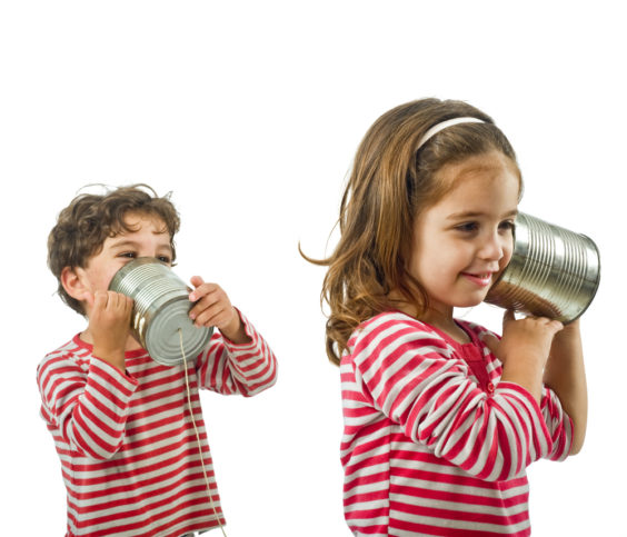 boy and girl talking on a tin phone isolated on white