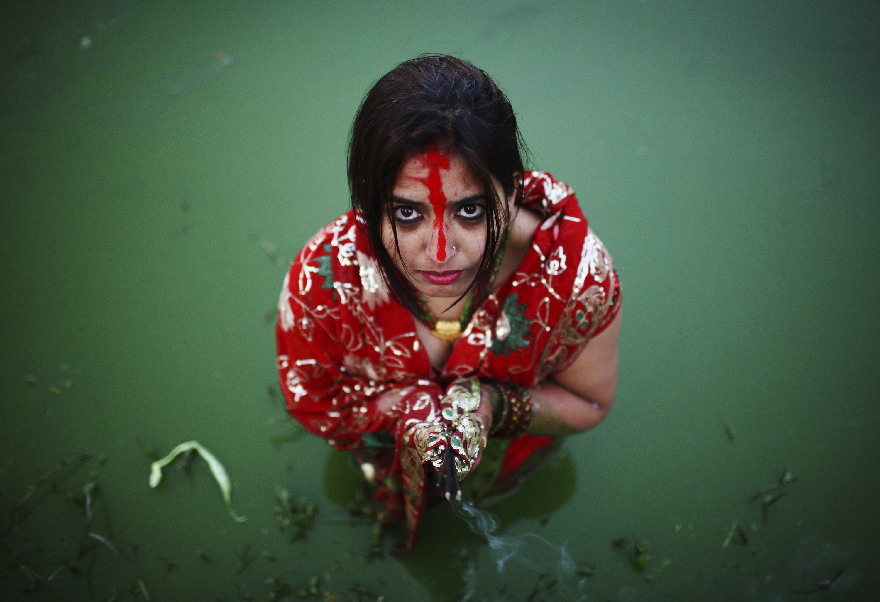 A devotee offers prayers to the rising sun during the "Chhat" festival in Kathmandu