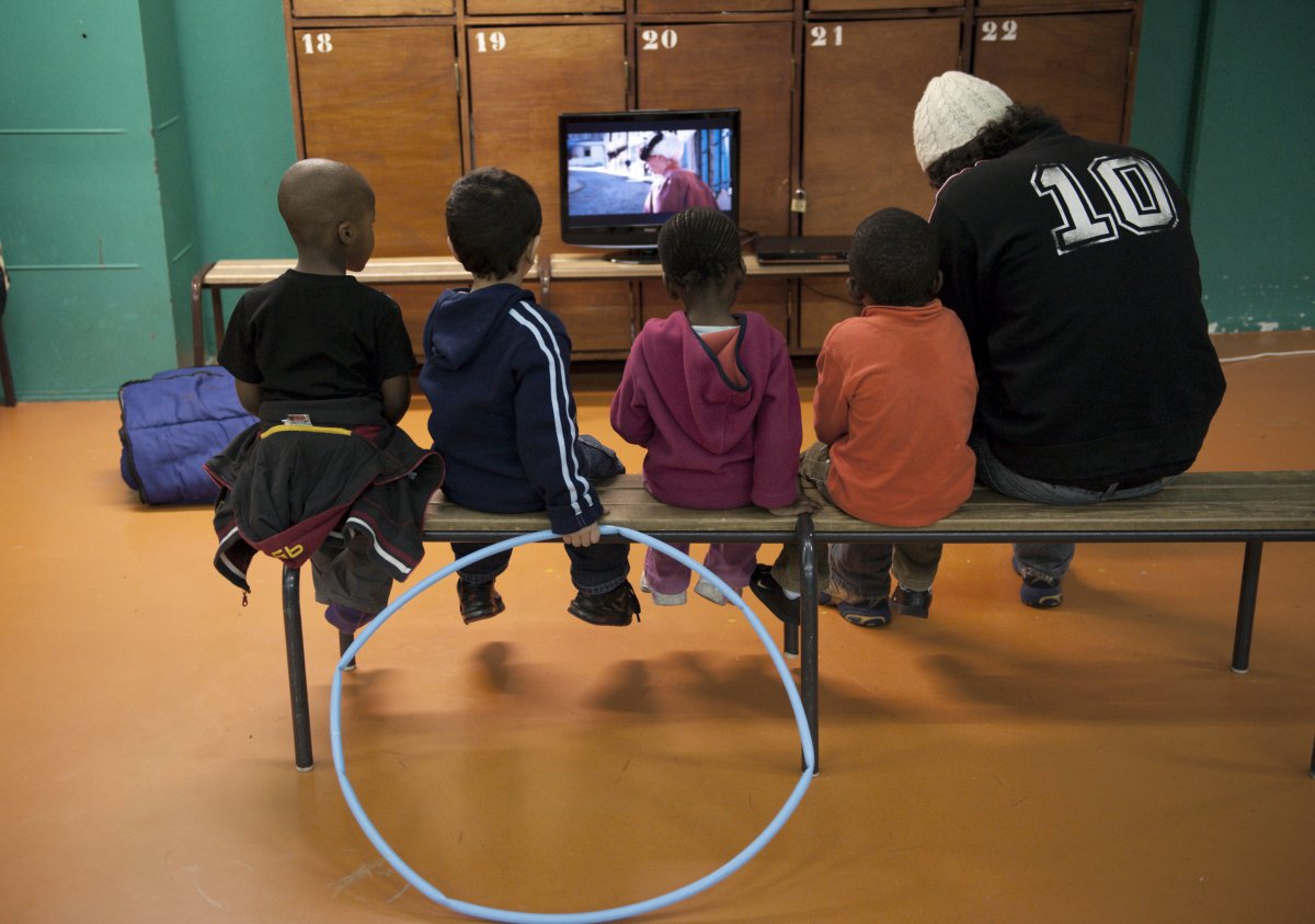 the-saint-merri-gym-in-paris-shows-tv-programming-as-children-sit-on-the-bench-and-watch