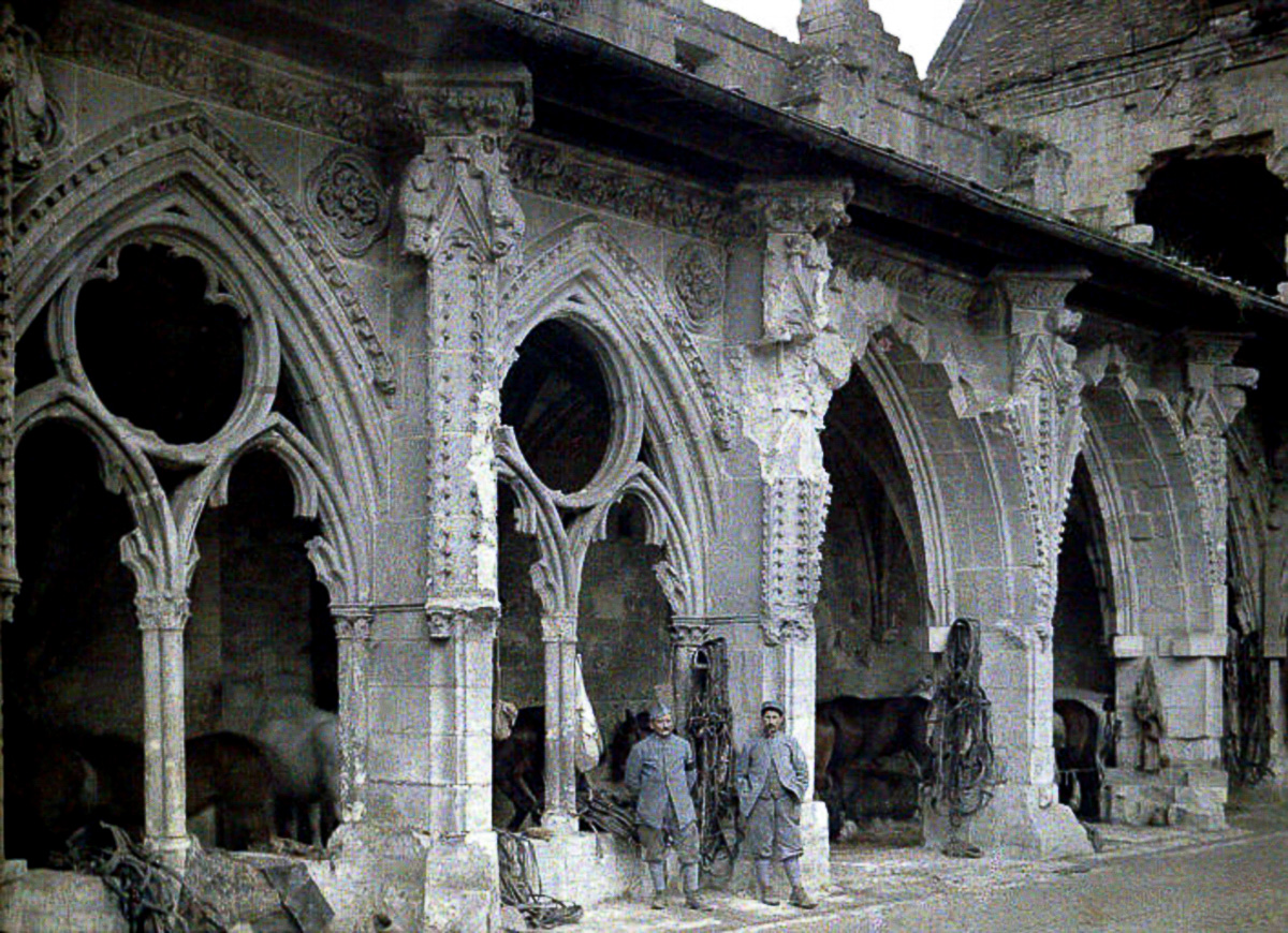 Two French soldiers and horses in the cloister of the abbey de Saint-Jean-des-Vignes, which was heavily damaged by artillery fire. 1917. Color photo (Autochrome LumiËre) by Fernand Cuville (1887-1927). World War I, Western Front. Soissons, Aisne, France. (Photo by Galerie Bilderwelt/Getty Images)